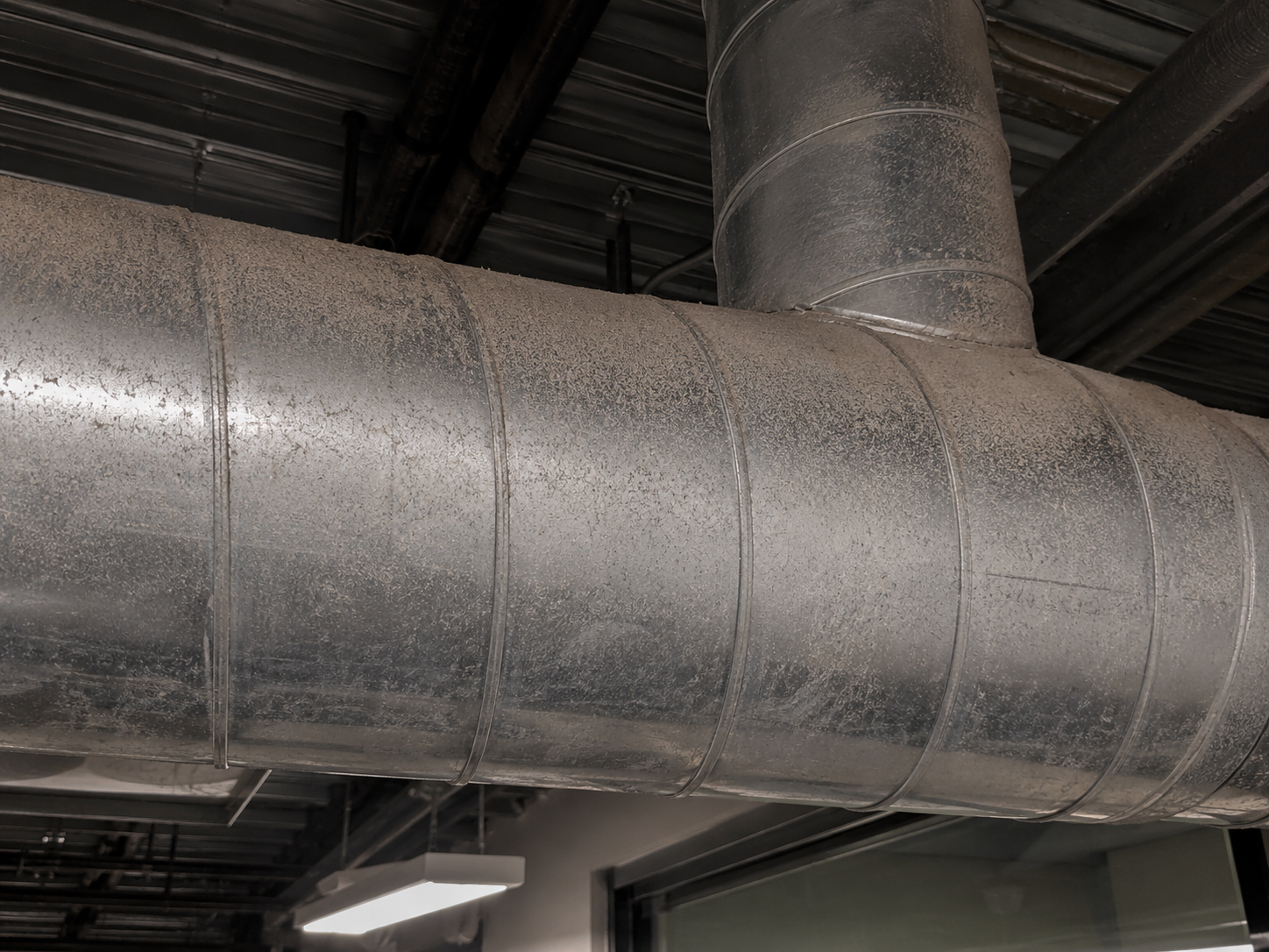 Dust-covered exposed duct before cleaning